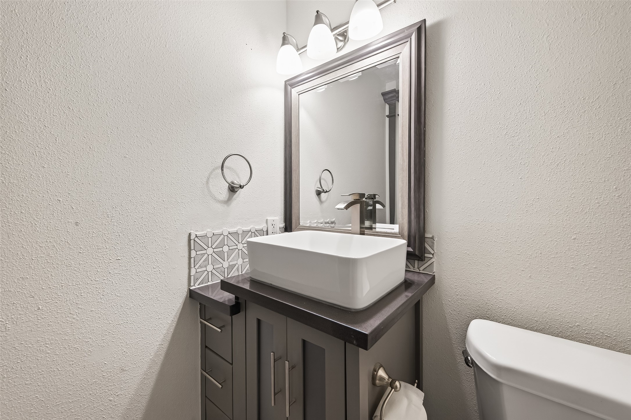 3684 Ocee Street Houston, TX 77063 - Photo 17 of 32 a bathroom with a sink toilet and mirror