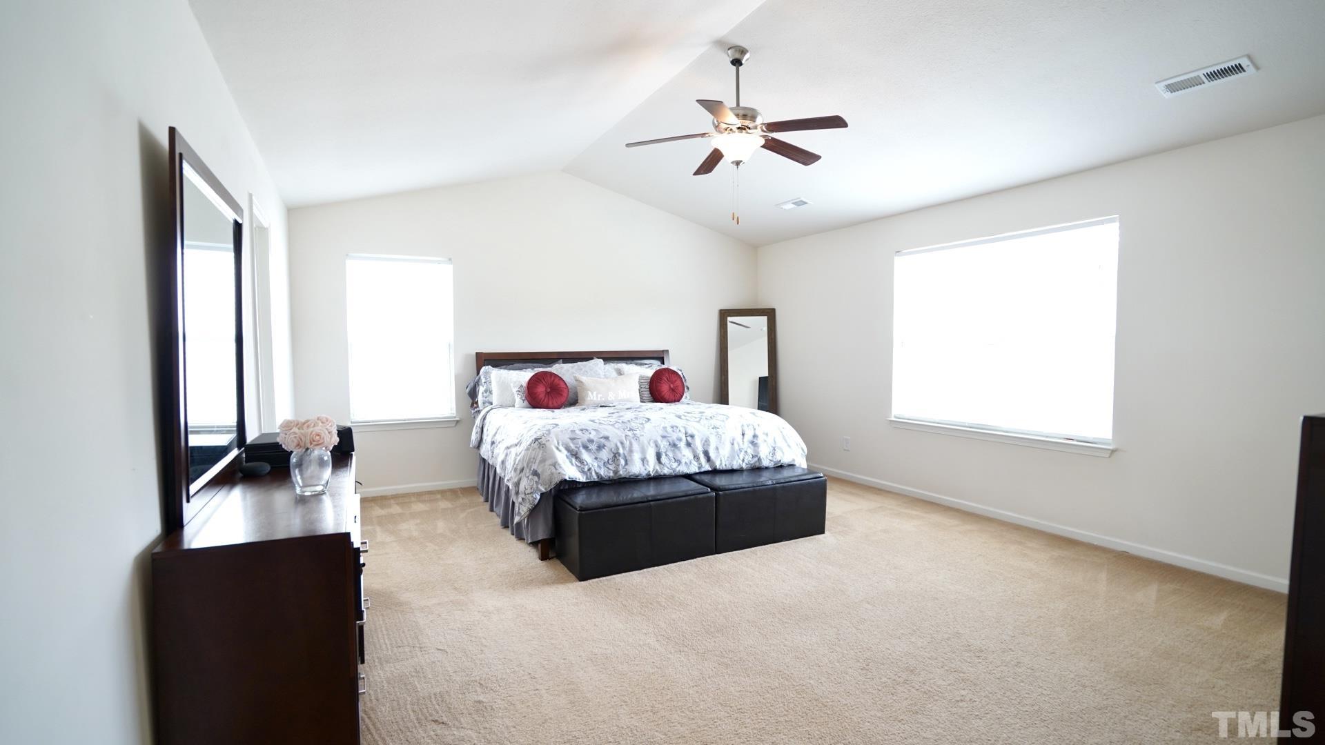 6813 Planting Court Raleigh, NC 27610 - Photo 5 of 9 a bed sitting in a bedroom next to a window