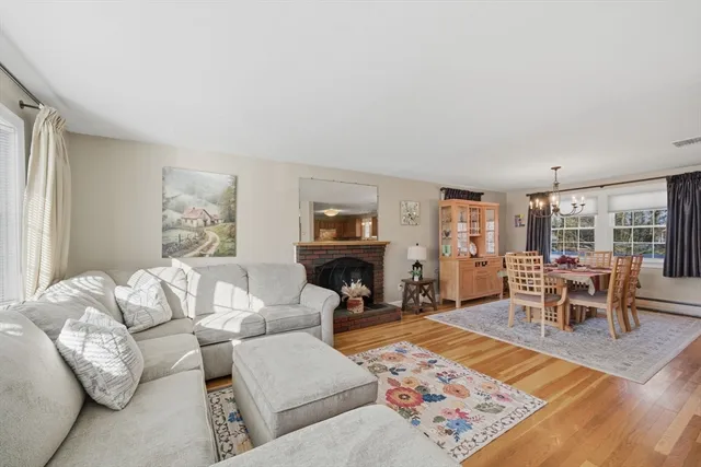a living room with furniture a rug and a fireplace