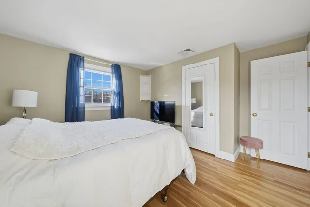 a bedroom with a bed and a dresser