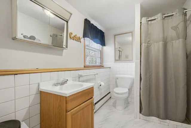 a bathroom with a sink mirror and toilet
