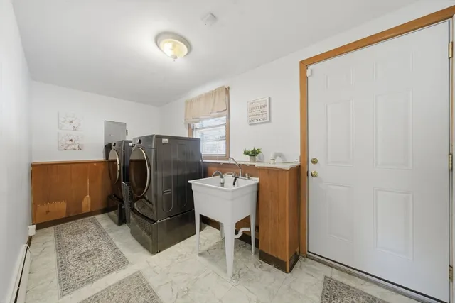 a view of a hallway with workspace and a window