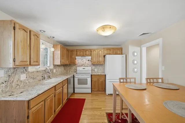 a large kitchen with kitchen island a sink stainless steel appliances and cabinets