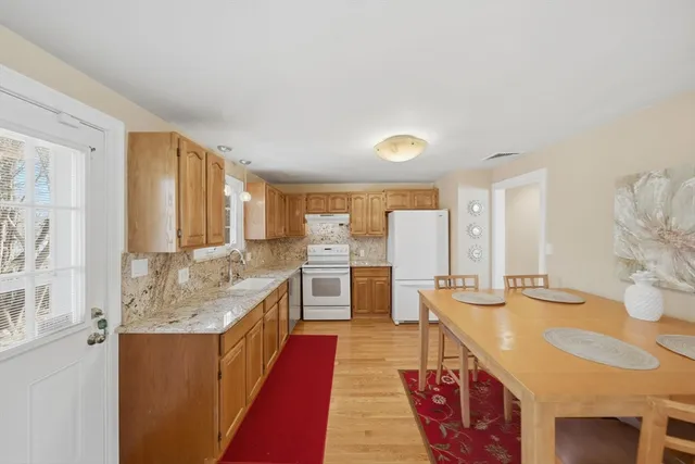 a spacious bathroom with a granite countertop double vanity sink and a bathtub