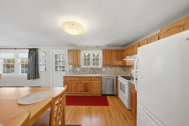 a kitchen with stainless steel appliances granite countertop a sink and a stove