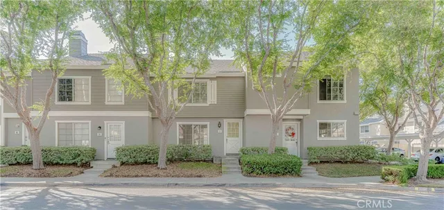 front view of a brick house next to a yard