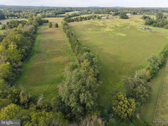 an aerial view of residential houses with outdoor space and river