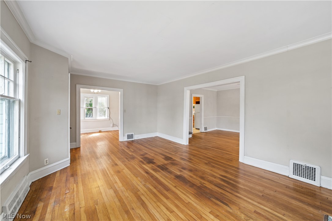 3076 Yorkshire Road Cleveland, OH 44118 - Photo 4 of 47 Empty room with crown molding and hardwood / wood-style floors