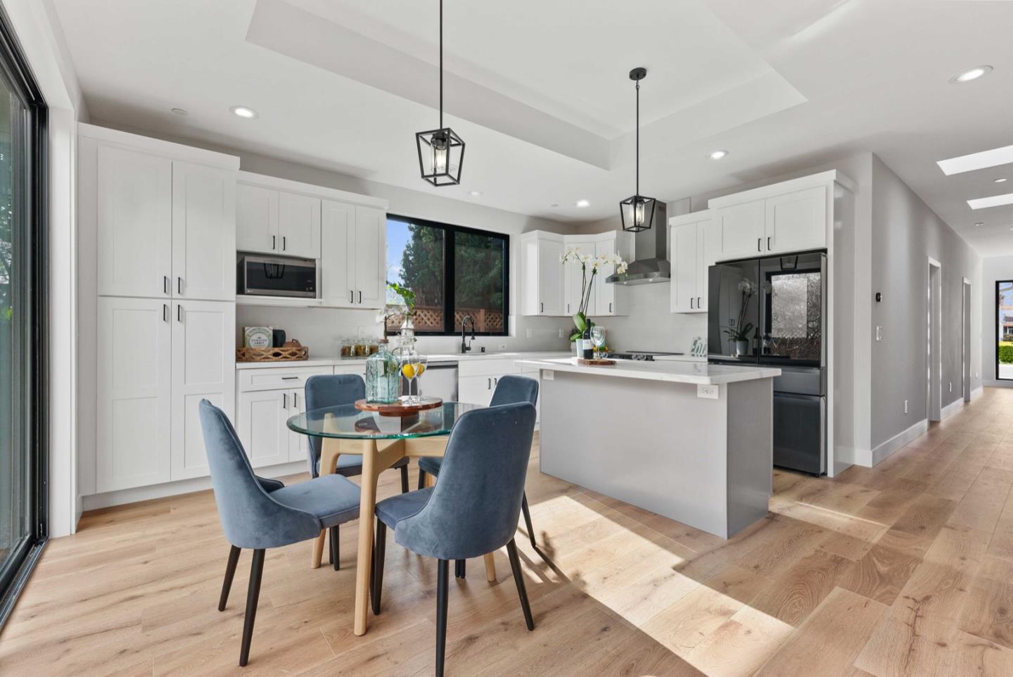 1766 Wagner Avenue Mountain View, CA 94043 - Photo 11 of 38 a kitchen with stainless steel appliances granite countertop a refrigerator a stove a microwave oven a sink dishwasher and a dining table with wooden floor