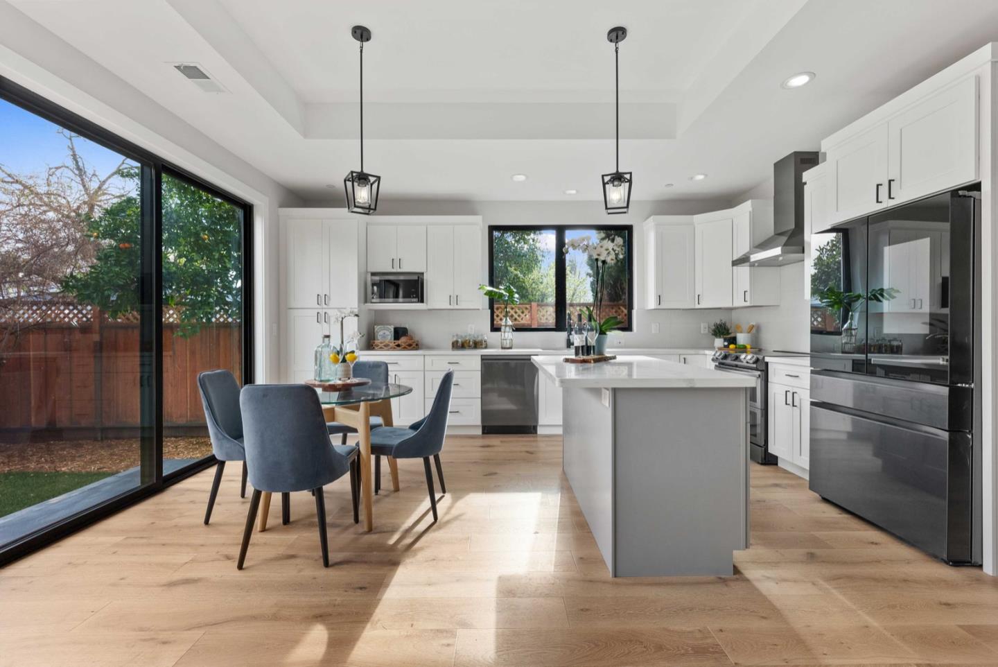1766 Wagner Avenue Mountain View, CA 94043 - Photo 12 of 38 a dining room with stainless steel appliances granite countertop a sink a refrigerator a stove a kitchen island with a dining table and chairs