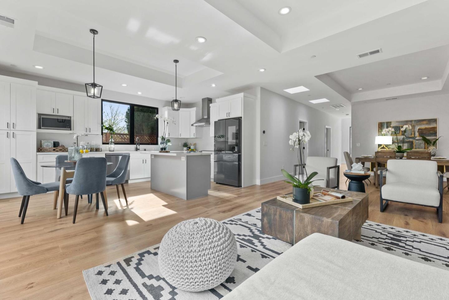 1766 Wagner Avenue Mountain View, CA 94043 - Photo 8 of 38 a living room with furniture a flat screen tv and kitchen view