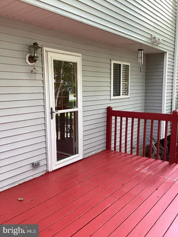a view of a house with roof and wooden wall