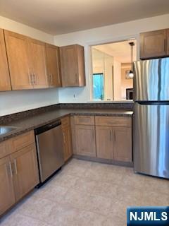 181 Long Hill Road, Unit N5 Little Falls, NJ 07424 - Photo 3 of 3 a kitchen with a refrigerator sink and cabinets