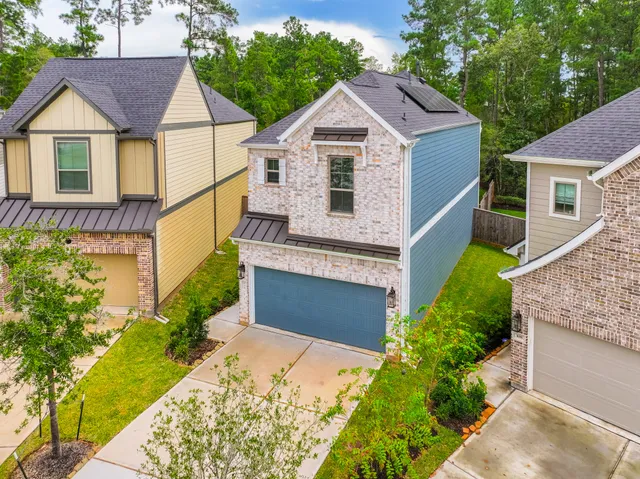 a front view of a house with a garden and plants