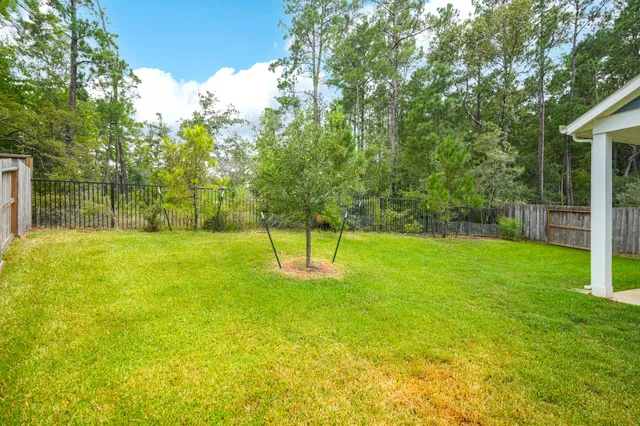 a view of a house with a yard and deck