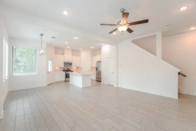a view of a livingroom with furniture ceiling fan and window