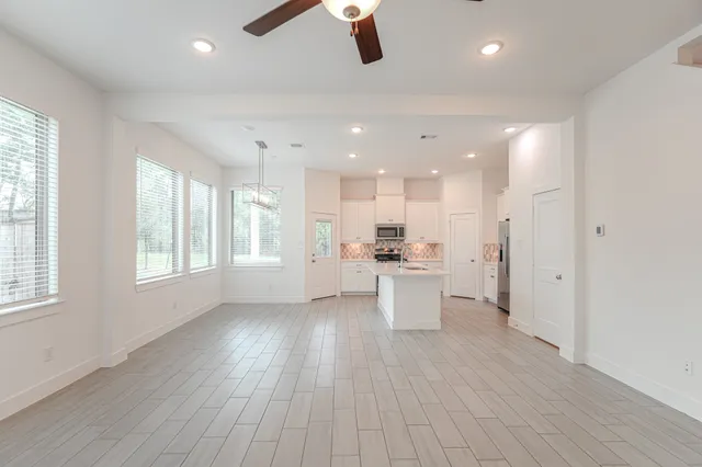 a view of kitchen with wooden floor and electronic appliances