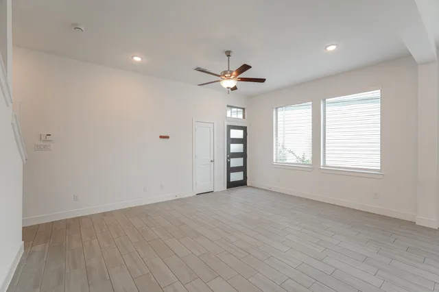 wooden floor in an empty room with a window