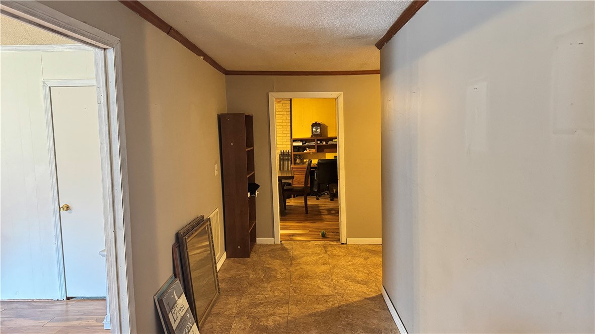 101 Due West Road Belton, SC 29627 - Photo 3 of 22 A well-lit hallway with durable flooring connects various functional areas of the home.