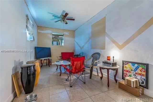 26420 Southwest 138th Court Homestead, FL 33032 - Photo 4 of 5 a living room with furniture and a flat screen tv