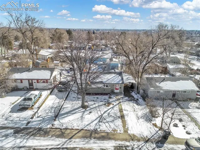 a view of a yard covered with snow in the background