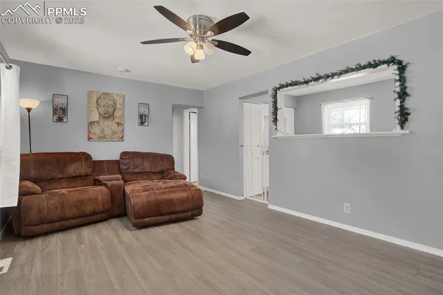 a living room with couches and a window