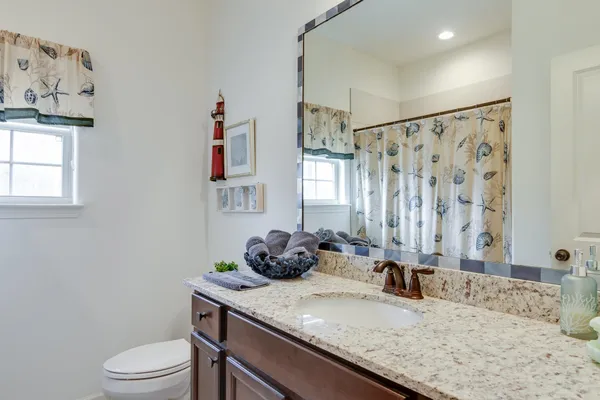 a very nice looking dining room with a large window wooden floor and a chandelier