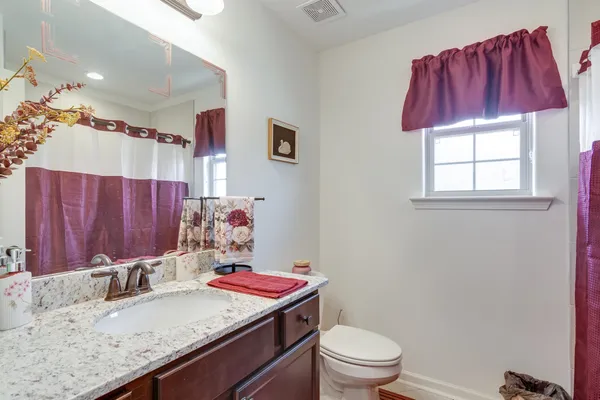 a bed room with a bed and a painting on the wall