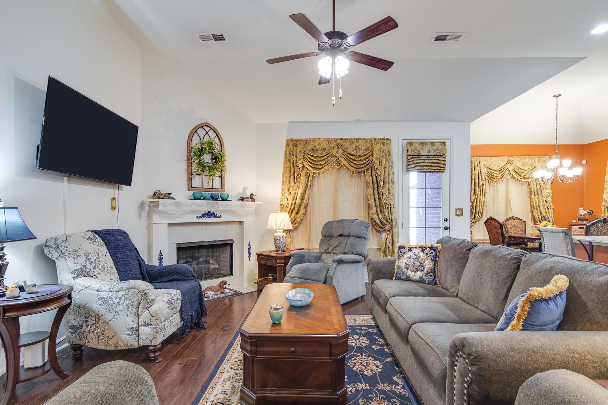 135 Chesnut Rdg Drive Oakland, TN 38060 - Photo 5 of 36 a living room with furniture a fireplace and a flat screen tv