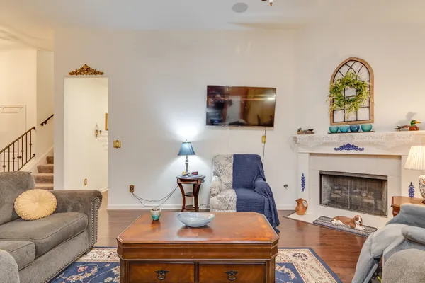 a living room with furniture a fireplace and a flat screen tv