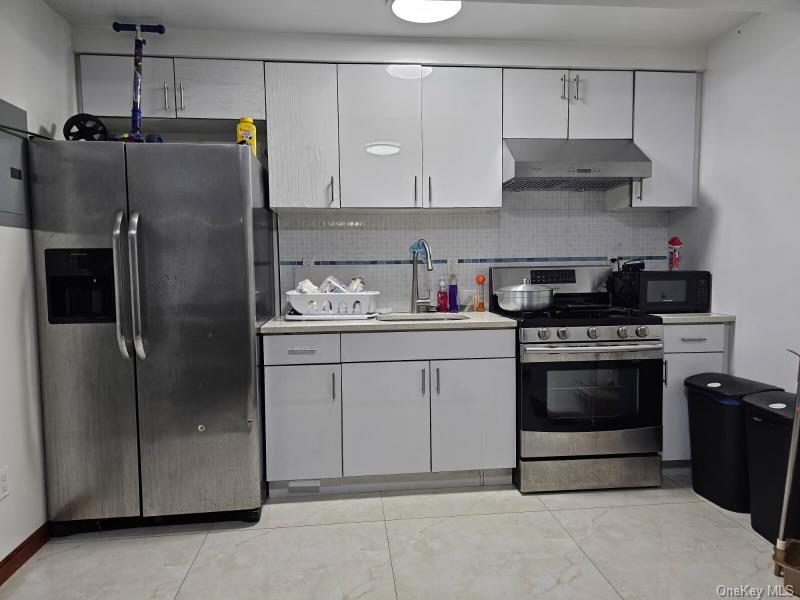 108-38 41st Avenue, Unit 1A Queens, NY 11368 - Photo 2 of 13 a kitchen with stainless steel appliances granite countertop a refrigerator and a stove