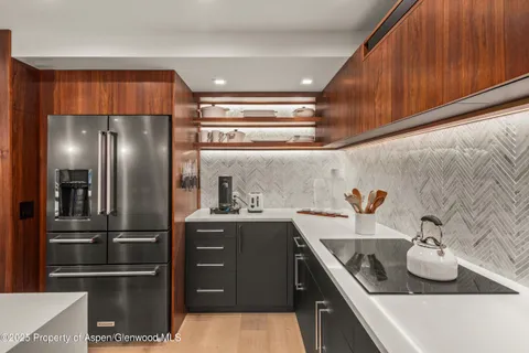a kitchen with stainless steel appliances granite countertop a refrigerator and a sink