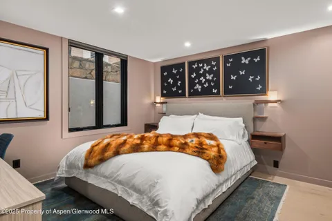 a bedroom with a large bed and a large window