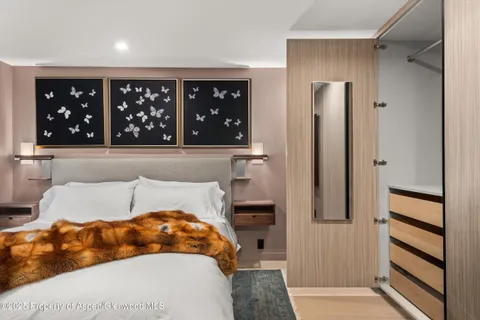 a bedroom with a large bed and a walk in closet
