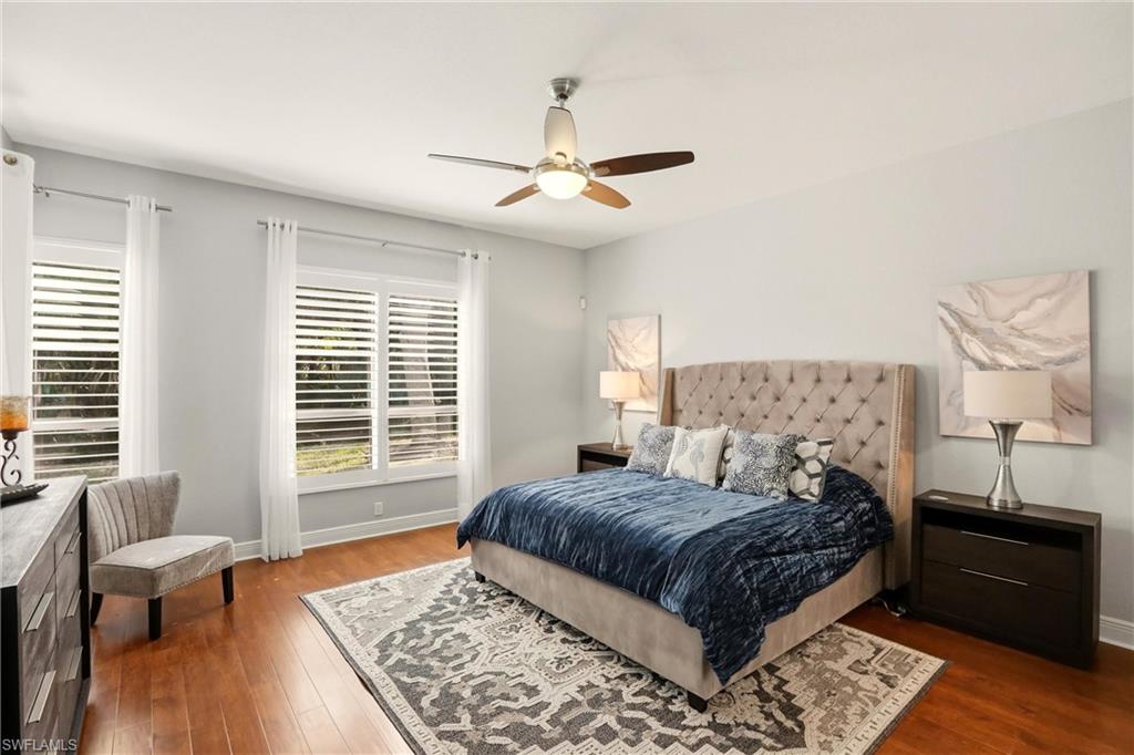 20441 Rookery Drive Estero, FL 33928 - Photo 18 of 41 a bedroom with a large bed and a couch