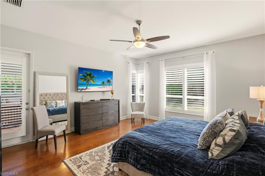 20441 Rookery Drive Estero, FL 33928 - Photo 19 of 41 a bedroom with a bed and a chair