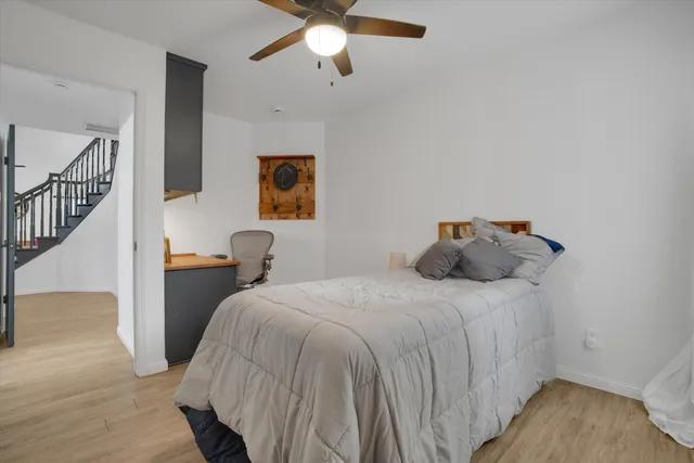 a bedroom with bed and a chandelier