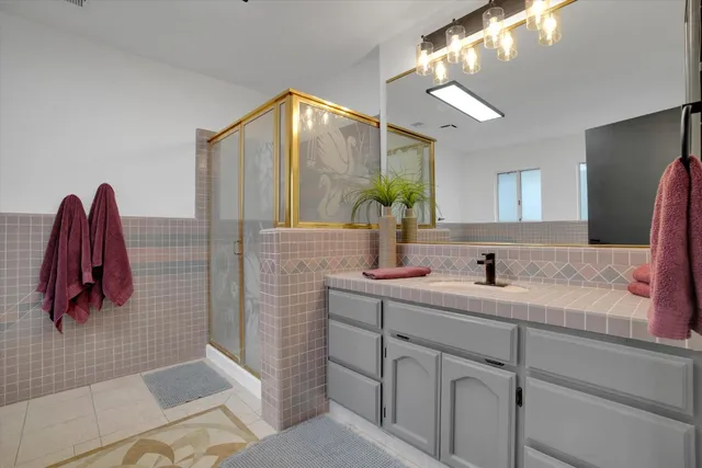 a bathroom with a sink a toilet and mirror