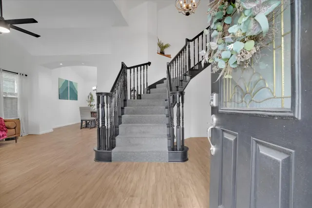 a view of entryway and hall with wooden floor