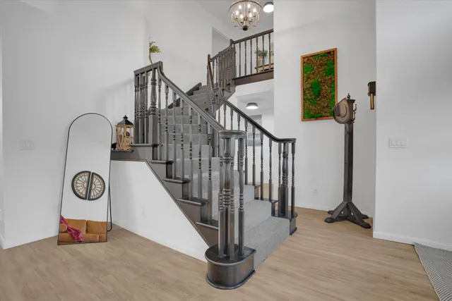 a view of entryway and hall with wooden floor