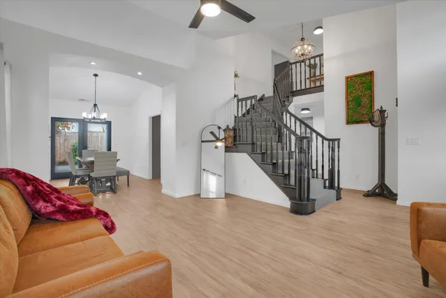 a living room with furniture and a chandelier