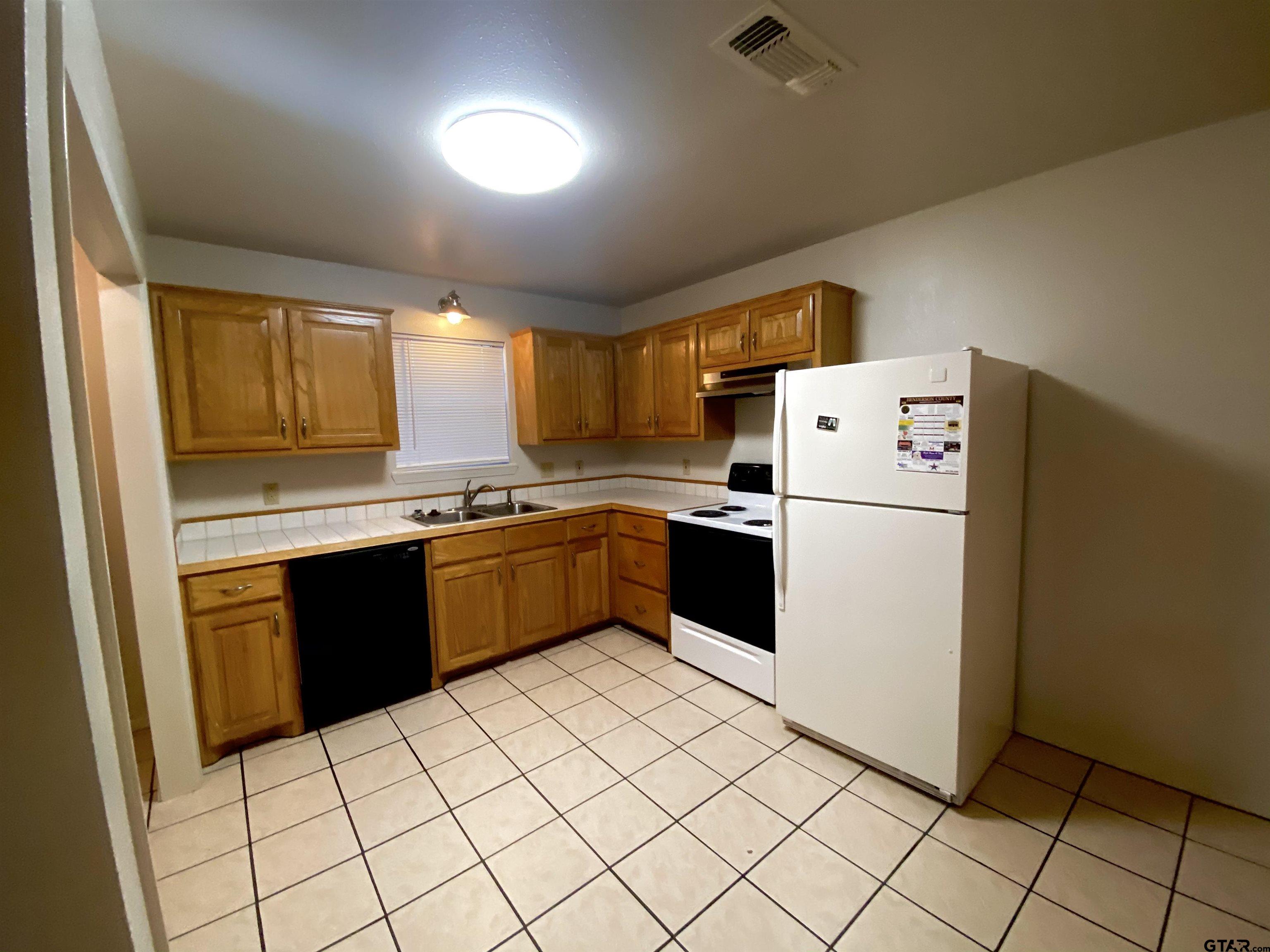 9650 Front Street Murchison, TX 75778 - Photo 4 of 11 a kitchen with a sink a stove top oven and cabinetry