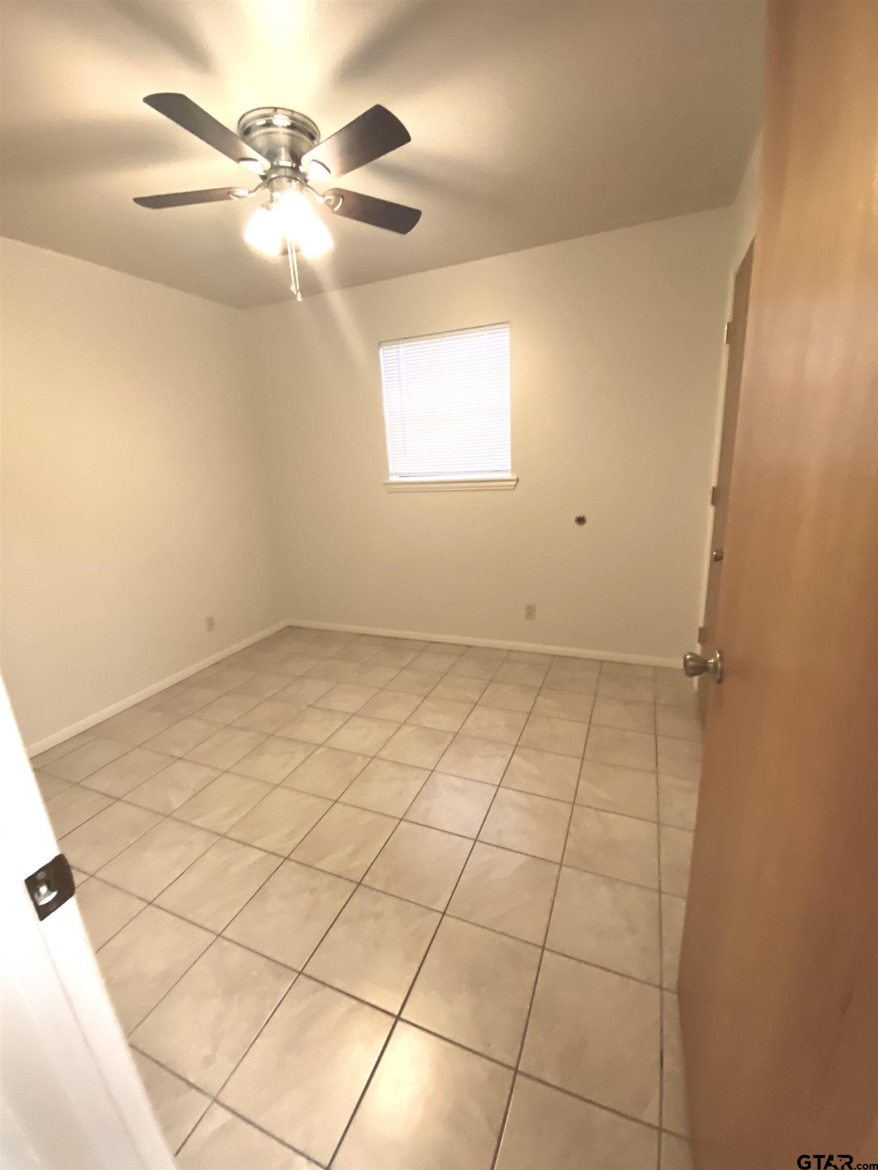 9650 Front Street Murchison, TX 75778 - Photo 10 of 11 an empty room with windows and fan