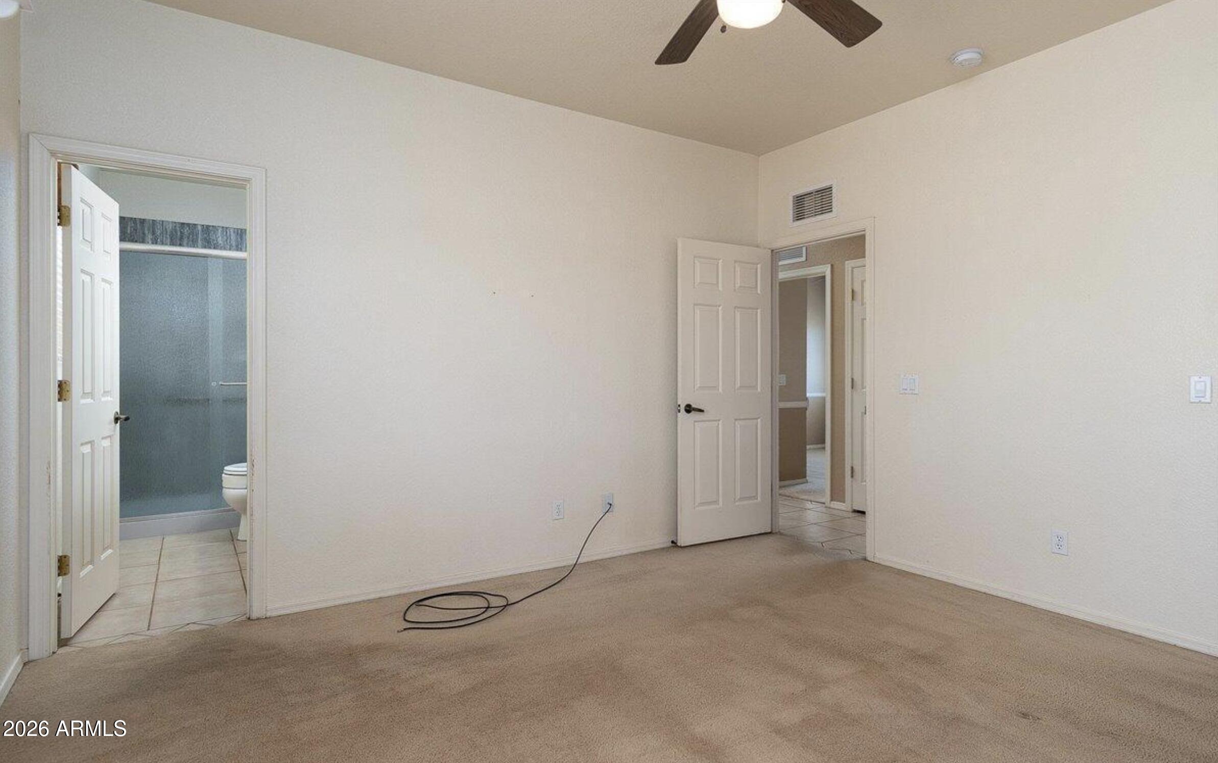 10193 East Windtalker Road Hereford, AZ 85615 - Photo 10 of 34 an empty room with closet and a chandelier fan