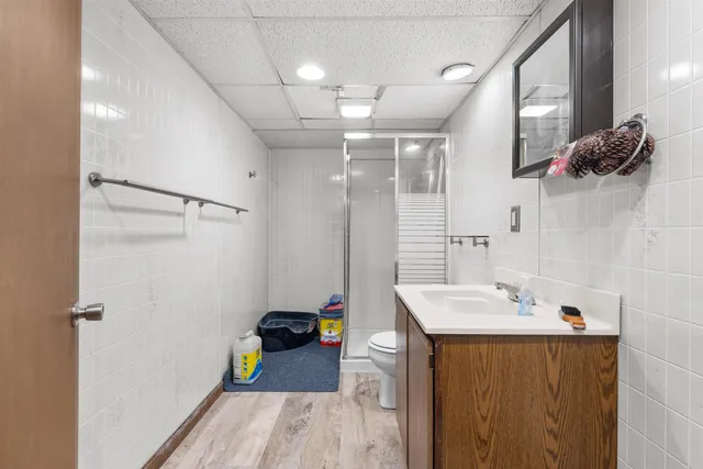 a bathroom with a sink mirror and shower