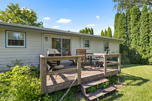 a view of a house with backyard and sitting area