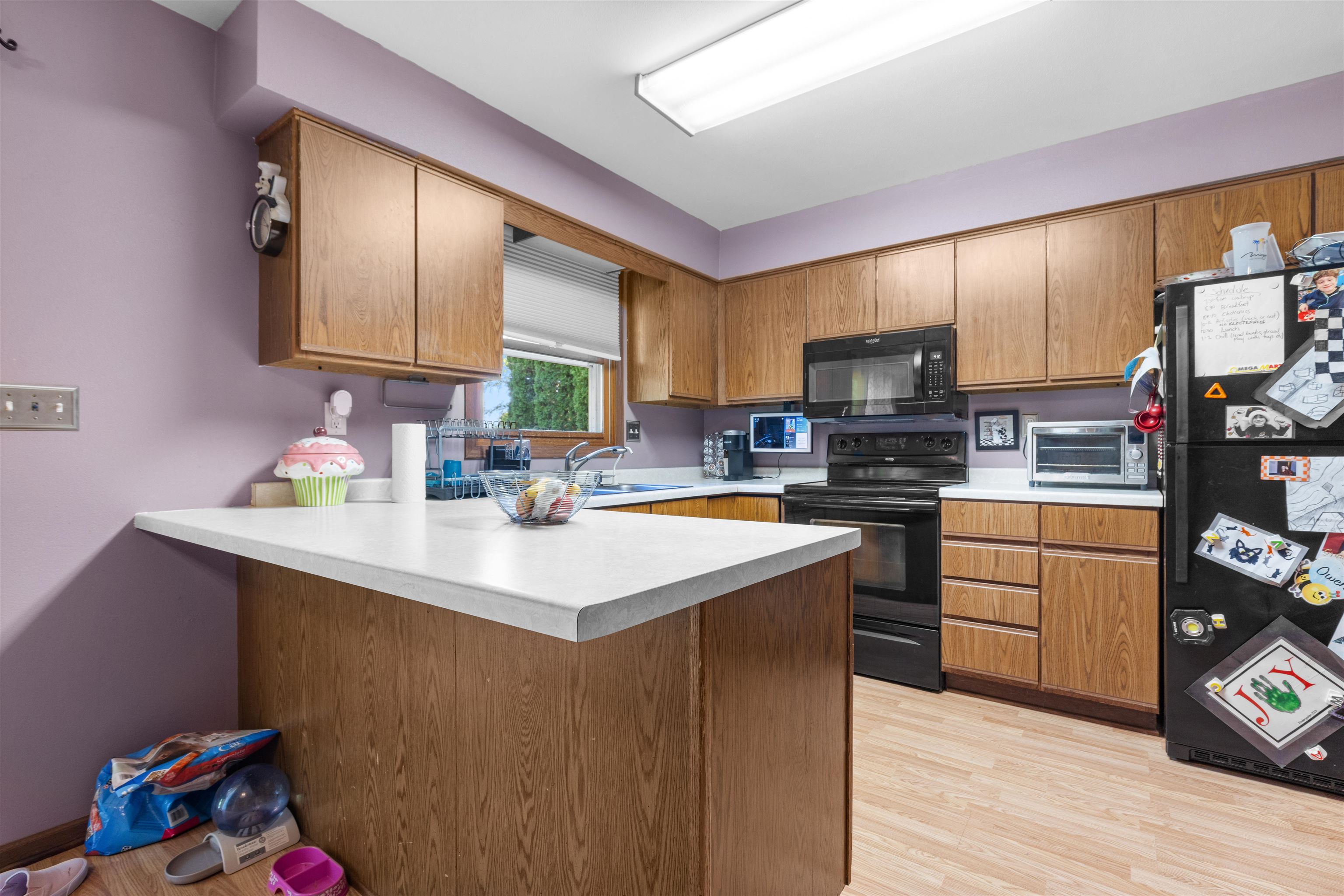 104 Deerpath Way Southwest Poplar Grove, IL 61065 - Photo 4 of 16 a kitchen with kitchen island granite countertop a sink cabinets and wooden floor