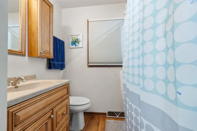 a bathroom with a sink a toilet and mirror