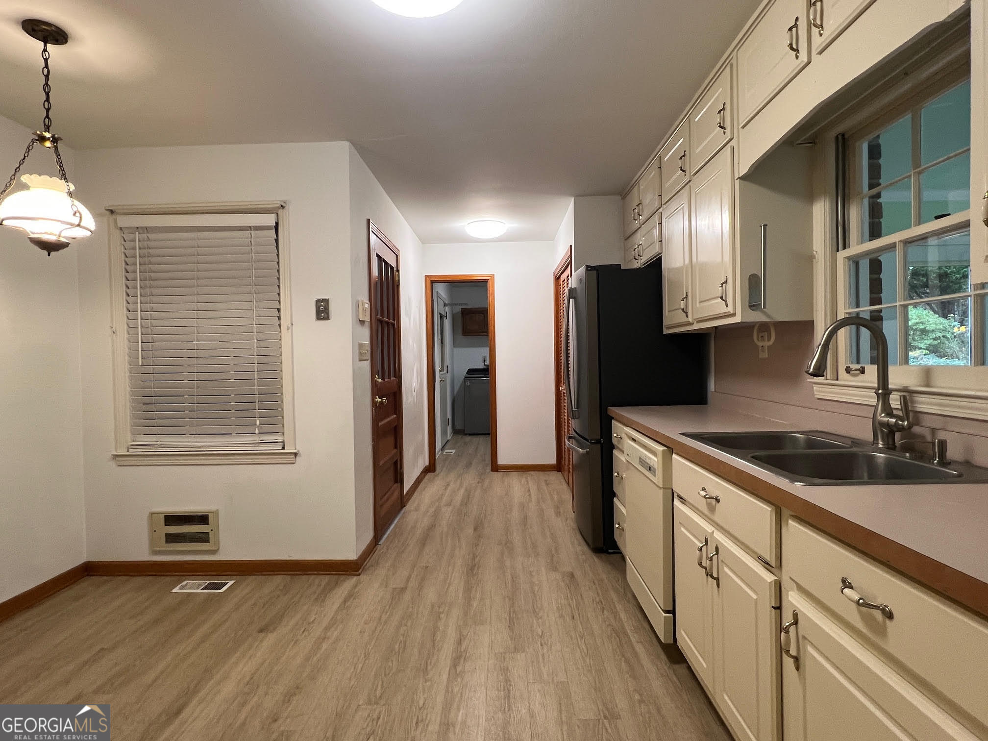 215 Old Oxford Road Covington, GA 30014 - Photo 11 of 19 a kitchen with stainless steel appliances granite countertop a sink and a refrigerator