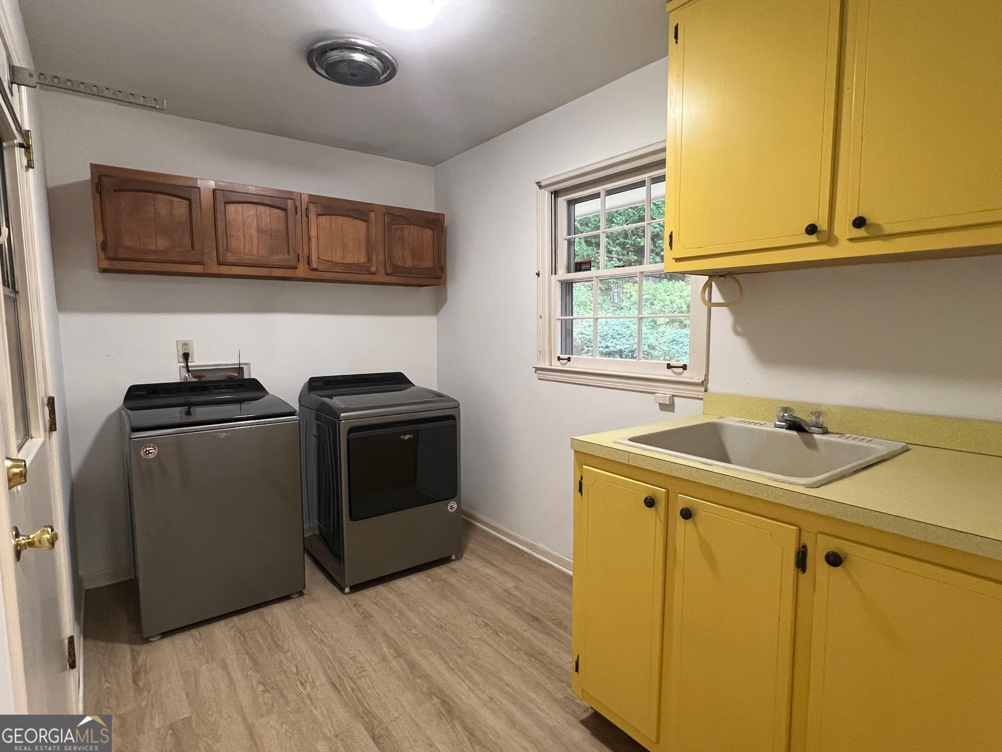 215 Old Oxford Road Covington, GA 30014 - Photo 12 of 19 a utility room with a sink washer and dryer